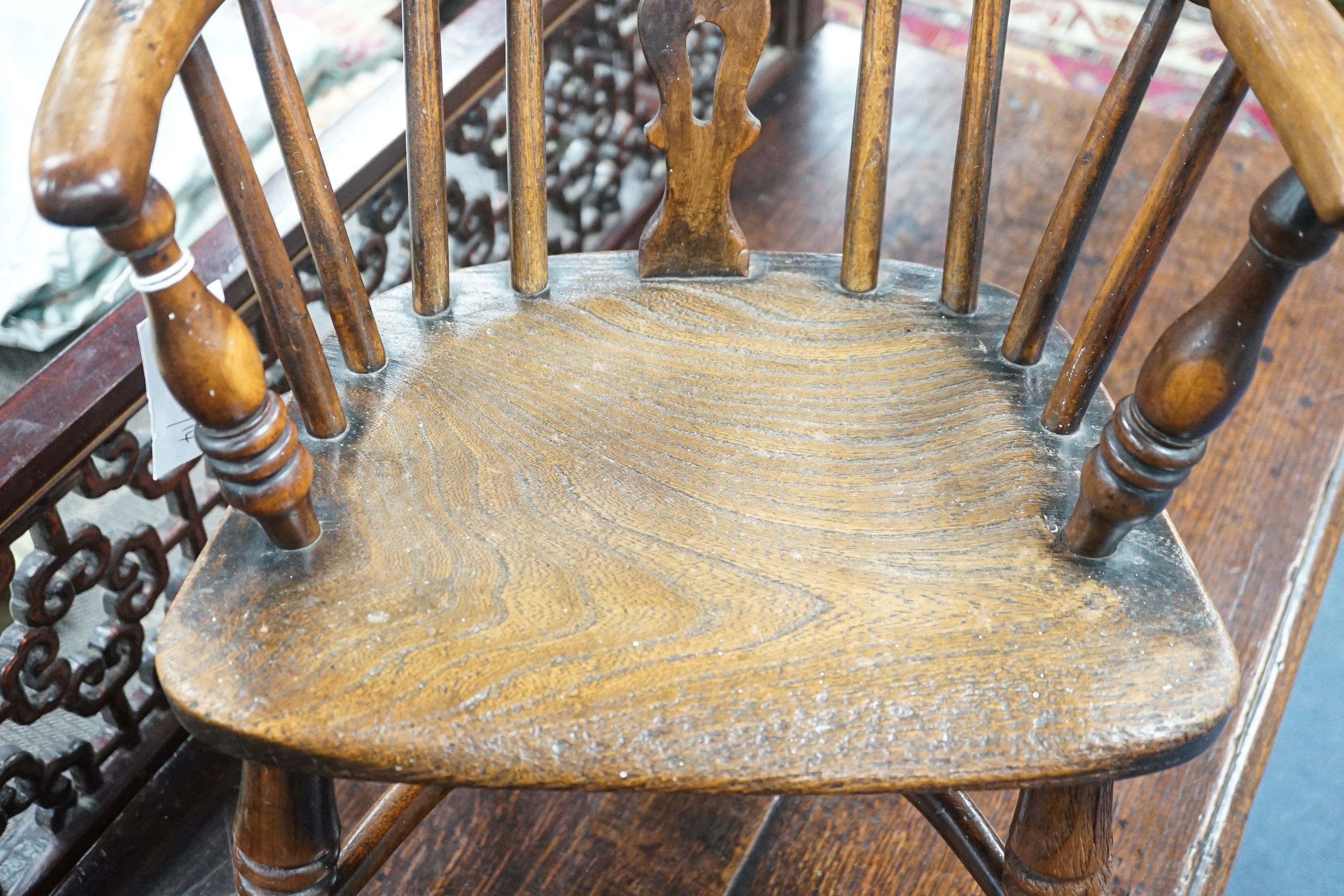 A 19th century Midlands area yew and elm Windsor child's elbow chair with crinoline stretcher, width 37cm, depth 44cm, height 65cm